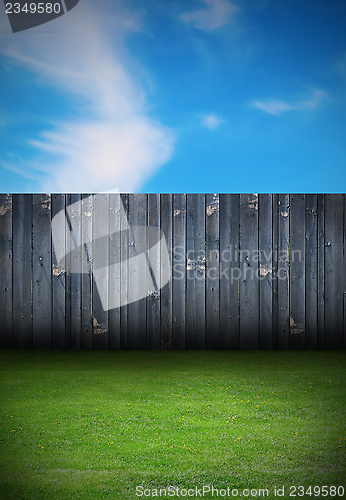 Image of backyard with old wooden fence