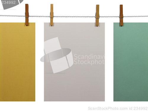 Image of Colorful paper sheets on a clothes line (+clipping path)