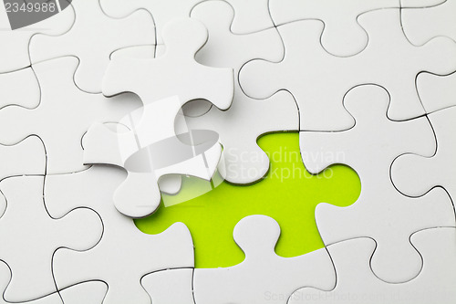 Image of Puzzle with missing piece in green color