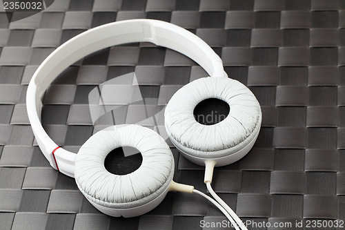 Image of Headphone on mat in black color 