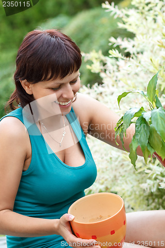 Image of happy smiling middle age woman gardening
