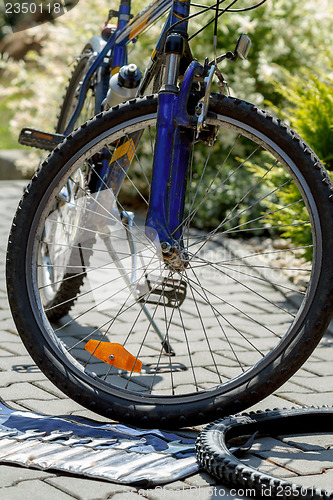 Image of Repair of bicycle, prepare to change old tyre with tools