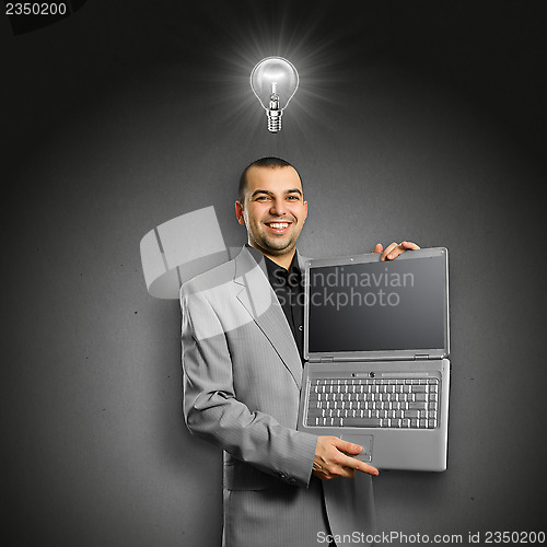 Image of Idea Concept businessman with open laptop in his hands