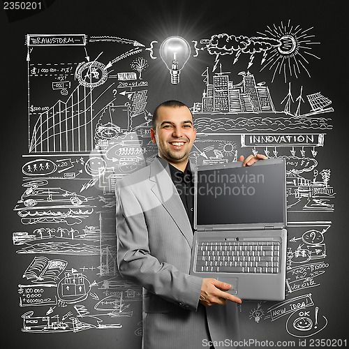 Image of Idea Concept businessman with open laptop in his hands