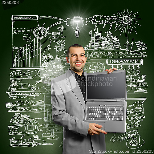 Image of Idea Concept businessman with open laptop in his hands