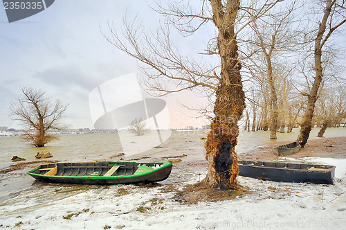 Image of green boat on shore in winter