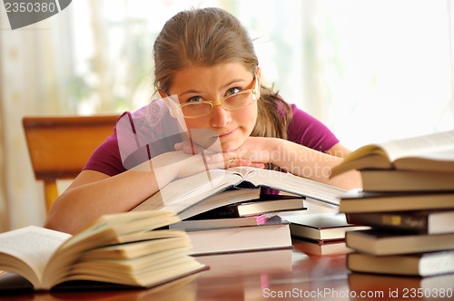 Image of Teen girl learning at the desk, looking up