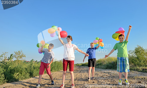Image of happy children with colorful balloons 