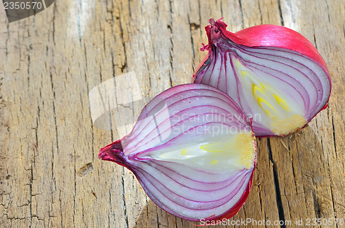 Image of Red onions isolated on wooden background