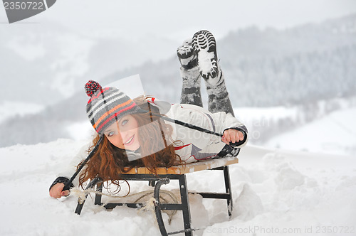 Image of young  girl on sleigh