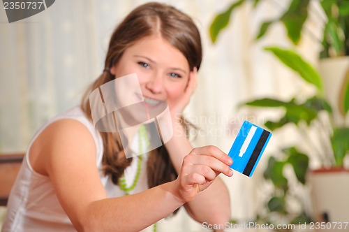 Image of teen girl with blank credit card 