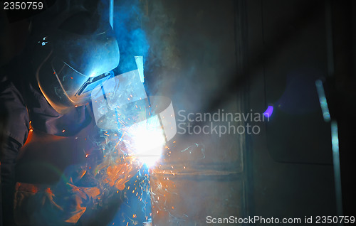 Image of Industrial worker welding in factory