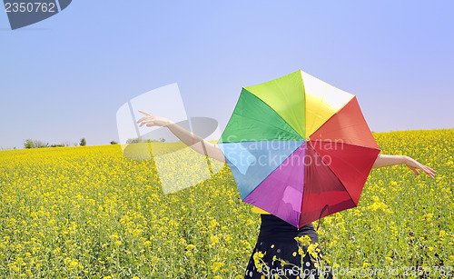 Image of a young attractive girl with a colorful umbrella