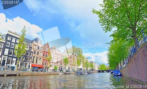 Image of Traditional Houses and house boat along canal in Amsterdam