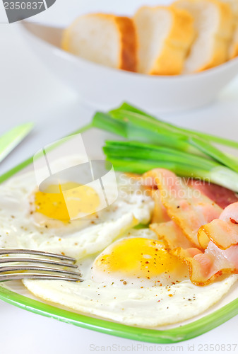 Image of breakfast with bacon and fried eggs 