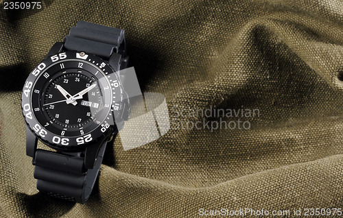 Image of military watch on sack background