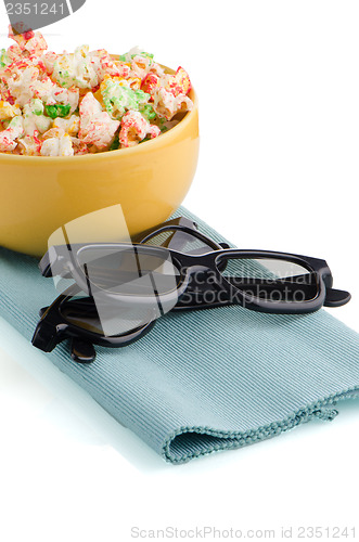 Image of Bowl of popcorn and 3D movie glasses