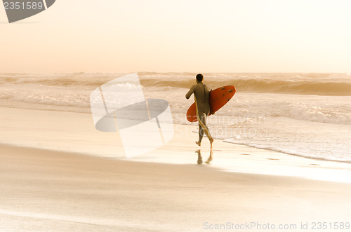 Image of Surfer running