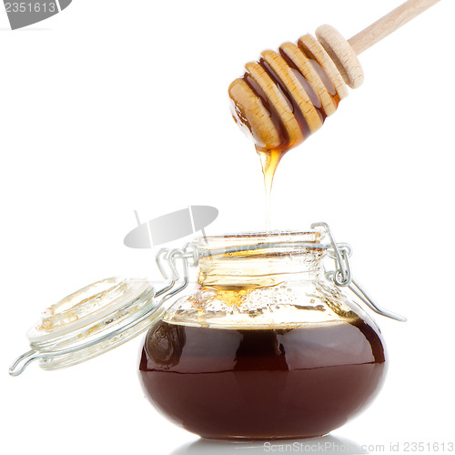 Image of Jar of honey with wooden drizzler