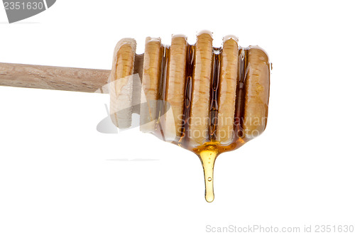 Image of Honey on wooden drizzler