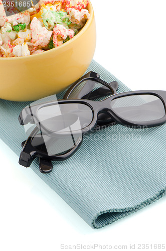 Image of Bowl of popcorn and 3D movie glasses