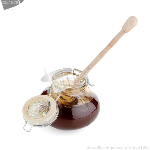 Image of Jar of honey with wooden drizzler