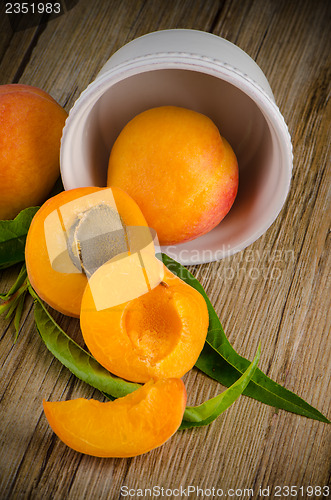 Image of Apricots on wooden table.