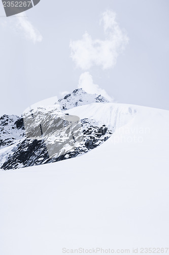 Image of Snowed mountain summit and rocks in Himalaya