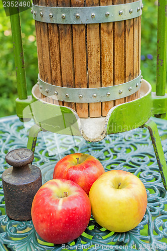 Image of apples with old fruit press
