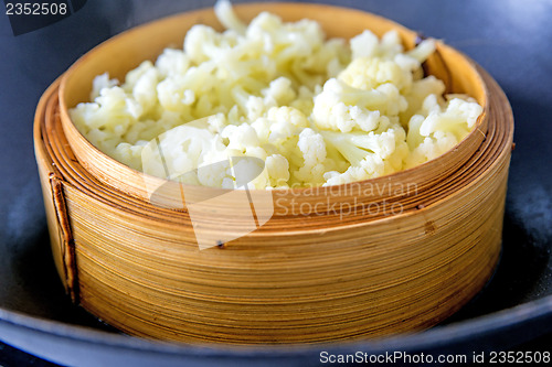 Image of chinese steam basket with cauliflower