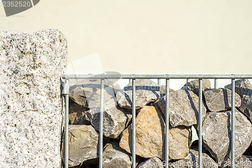 Image of steel fence with stones