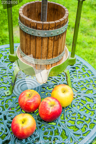 Image of apples with old fruit press