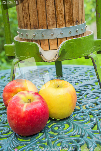 Image of apples with old fruit press