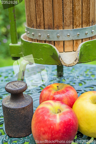 Image of apples with old fruit press