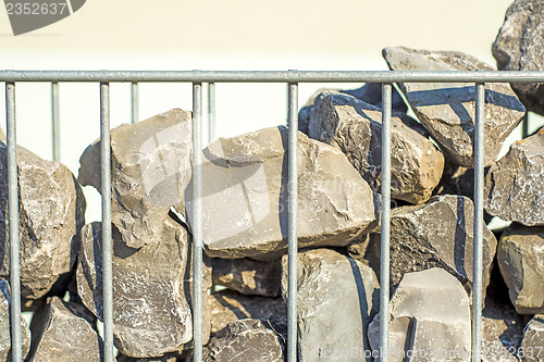 Image of steel fence with stones