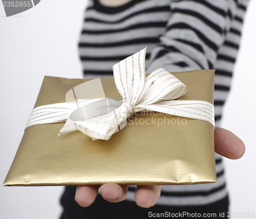 Image of Young woman holding a present