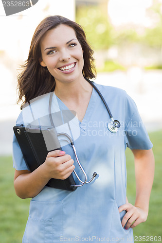 Image of Young Adult Woman Doctor or Nurse Holding Touch Pad