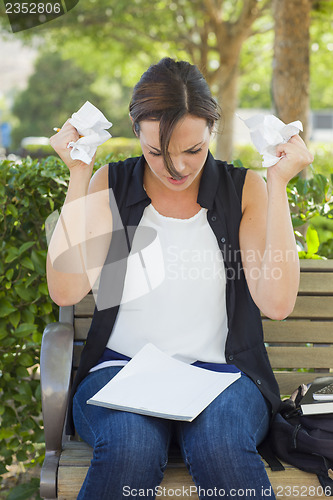 Image of Upset Young Woman with Pencil and Crumpled Paper in Hands