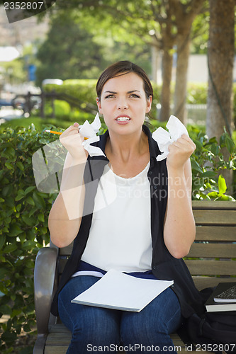 Image of Upset Young Woman with Pencil and Crumpled Paper in Hands