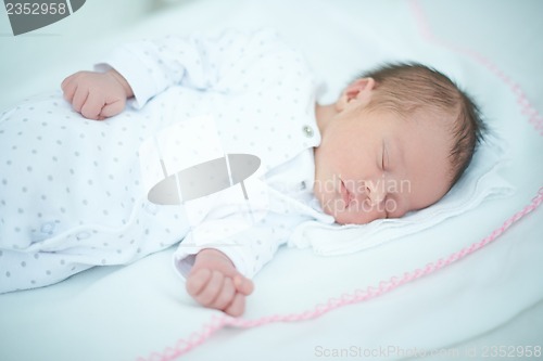 Image of Adorable Child Sleeping on White Blanket