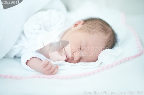 Image of Adorable Baby Girl is Sleeping on Bed
