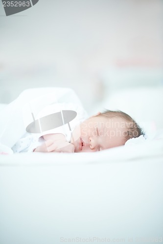 Image of Newborn Baby Laying on White Bed