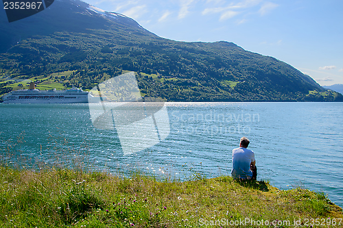 Image of A man watching a cruise ship