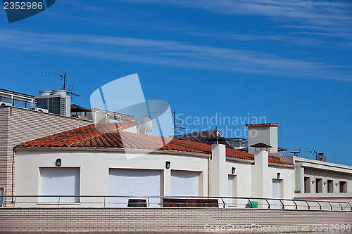 Image of white stone house with red tiled