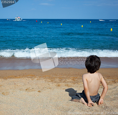 Image of child sitting on the shore