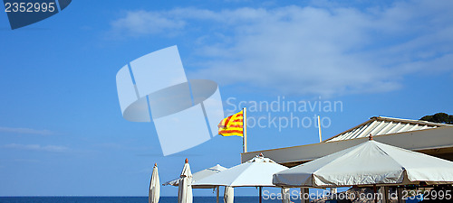 Image of White umbrellas and the flag of Catalunya