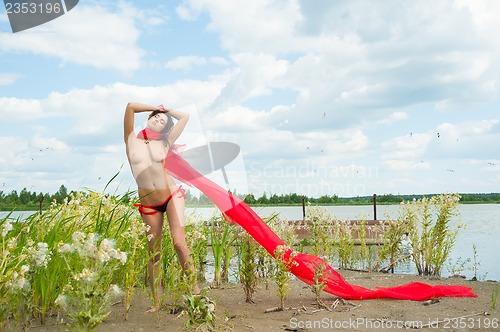 Image of Attractive naked girl on river bank