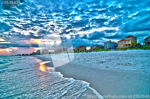 Image of sunset on florida beach with white sand and blue sky