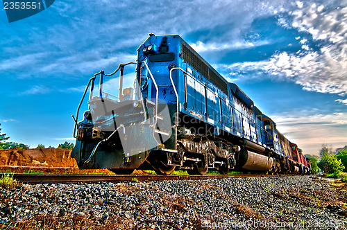 Image of blue freight train engine at sunrise 