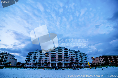 Image of sunset on florida beach with white sand and blue sky